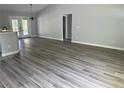 Spacious living room with luxury vinyl plank flooring, neutral paint, and ample natural light at 14 Bay Terrace Pass, Ocklawaha, FL 32179
