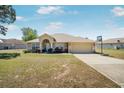 Charming single-story home featuring a two-car garage and well-maintained front lawn at 17 Pine Course Loop, Ocala, FL 34472