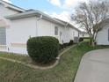View of side yard showing manicured landscaping, rock borders, and the home's exterior at 2459 Nw 55Th Avenue Rd, Ocala, FL 34482