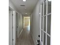Bright hallway with modern flooring and neutral walls leads to other rooms at 31 Juniper Pass Ln, Ocala, FL 34480