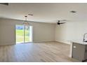 Open-concept living space with ample natural light and sliding glass door to backyard at 31 Juniper Pass Ln, Ocala, FL 34480