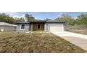 Charming single-story home featuring a two-car garage and modern design at 4059 Sw 131St Place Rd, Ocala, FL 34473