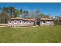 Beautiful single-story home features a well-manicured lawn and inviting front entrance at 4869 Nw 101St Street Rd, Ocala, FL 34482