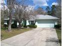 Spacious one-story home with an attached two-car garage and a long driveway for ample parking at 5181 Sw 164Th Street Rd, Ocala, FL 34473