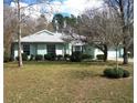 Inviting one-story home featuring a lush front lawn, mature trees, and manicured shrubbery for a serene setting at 5181 Sw 164Th Street Rd, Ocala, FL 34473