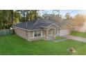 Lovely single-story home featuring a well-kept lawn and a convenient attached two-car garage at 5758 Nw 63Rd Pl, Ocala, FL 34482