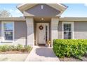 Inviting front entrance with decorative wreath, manicured bushes, and pot of flowers at 7092 Sw 93Rd Ave # 1, Ocala, FL 34481