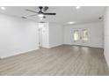 Spacious living room features recessed lighting, gray wood-look flooring, and french doors at 7280 Se County Highway 25A, Belleview, FL 34420
