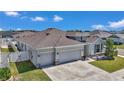 An aerial view of a single-Gathering home featuring a well-manicured yard and a spacious two-car garage at 8371 Sw 59Th Ter, Ocala, FL 34476