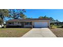 Charming single-story home with a well-maintained lawn and a two-car garage at 8516 Sw 105Th Pl, Ocala, FL 34481