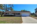 Charming single-story home with a well-maintained lawn and a two-car garage at 8516 Sw 105Th Pl, Ocala, FL 34481