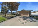 Beautiful home with an inviting driveway design, a large shade tree, and a two-car garage at 9463 Sw 93Rd Loop, Ocala, FL 34481