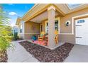 Cozy front porch with seating, decorative accents, and manicured landscaping enhancing the curb appeal at 9841 Sw 95Th Loop, Ocala, FL 34481