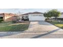 Exterior features include a driveway, a two-car garage, and well-kept landscaping at 10071 Sw 90Th Loop, Ocala, FL 34481