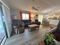 Comfortable living room adjacent to the kitchen and dining area, perfect for entertaining at 1118 Pelion Pl, The Villages, FL 32162