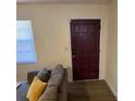 Inviting living room featuring a modern door and a large window with blinds at 1127 Enchanted Dr, Lakeland, FL 33801