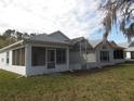View of the home's screened in back porch, and the neighboring homes in the distance at 11665 Sw 72Nd Cir, Ocala, FL 34476