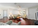 Inviting living room with hardwood floors, a ceiling fan, and comfortable seating near a window at 2013 Cardona Way, The Villages, FL 32159