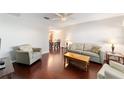 Bright living room featuring hardwood floors, neutral walls, and traditional furnishings at 2013 Cardona Way, The Villages, FL 32159
