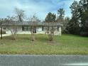 A cozy single-story house with a well-maintained front yard at 23 Juniper Pass Ln, Ocala, FL 34480