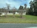 Well-maintained single-story house with a mature landscaped front yard at 23 Juniper Pass Ln, Ocala, FL 34480