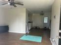 Open-concept living room featuring wood-look floors and a ceiling fan at 23 Juniper Pass Ln, Ocala, FL 34480