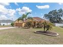 Beautiful single Gathering home with a front yard featuring mature palm trees at 234 Locust Pass Loop, Ocala, FL 34472