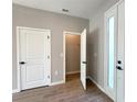 Bedroom with tile floors and walk-in closet; an adjacent door and window provide ample lighting at 3628 Sw 133Rd Loop, Ocala, FL 34473