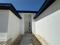 A well-lit front entrance with a modern pathway and bright, white walls at 3628 Sw 133Rd Loop, Ocala, FL 34473