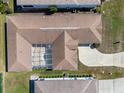 An aerial view of a single-Gathering home, showcasing a pool enclosure, driveway, and landscaping at 5891 Nw 26Th St, Ocala, FL 34482