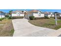 Lovely one-story home featuring a curved driveway, well-maintained landscaping, and a two-car garage at 5891 Nw 26Th St, Ocala, FL 34482