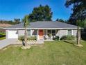 Charming single-story home with well-manicured lawn and inviting front porch seating area at 622 Nw 56Th Ave, Ocala, FL 34482