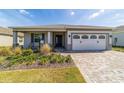 Well-manicured lawn and landscaping highlight this charming single-story home with a brick-paved driveway at 7908 Sw 89Th Cir, Ocala, FL 34481
