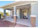 Inviting front porch with brick columns and railings, perfect for relaxing outdoors at 8342 Sw 82Nd Loop, Ocala, FL 34481