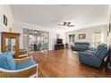 Bright living room features hardwood floors, ceiling fan, and sliding doors to lanai at 8342 Sw 82Nd Loop, Ocala, FL 34481
