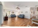 Spacious living room with hardwood floors, ceiling fan and ample natural light at 8342 Sw 82Nd Loop, Ocala, FL 34481