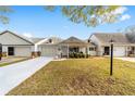 Well-maintained home with front lawn and covered porch with seating and blue shutters at 8350 Sw 93Rd Ln # C, Ocala, FL 34481