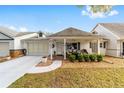 Charming single-story home with a covered porch, attached garage, and manicured front yard at 8350 Sw 93Rd Ln # C, Ocala, FL 34481