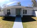Inviting home exterior featuring a charming front entrance and manicured lawn at 8890 Sw 33Rd Ct, Ocala, FL 34476