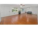 Bright living room featuring hardwood floors, large windows, and traditional decor at 11 Se 31St St, Ocala, FL 34471