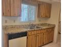 Kitchen with wood cabinets, stone counters, stainless steel sink and white appliances at 11255 Sw 76Th Ter, Ocala, FL 34476