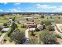 Expansive estate featuring a stunning home, a lush landscape, and serene pond views at 12424 Sw 140Th Loop, Dunnellon, FL 34432