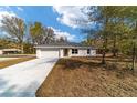 Inviting single-story home featuring a clean driveway and freshly prepped landscaping at 13495 Sw 114Th Ln, Dunnellon, FL 34432