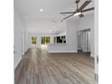 Bright, open-concept living space with modern wood floors, natural light, and a view into the kitchen at 14409 Sw 30Th Street Rd, Ocala, FL 34481