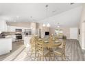 Open-concept dining area featuring modern table set, stainless steel appliances, and seamless connection to the living room at 20764 Sw Starling Dr, Dunnellon, FL 34431