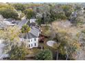 Aerial view of a home showcasing its backyard deck, lush greenery, and surrounding neighborhood at 30 Se Wenona Ave, Ocala, FL 34471