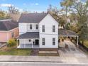 Charming two-story home boasting classic architecture, a covered porch, and a convenient carport at 30 Se Wenona Ave, Ocala, FL 34471