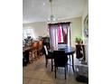 Bright dining area with a marble table, seating for four, tiled flooring, and sliding glass doors to the outdoor space at 310 Oak Track Dr, Ocala, FL 34472