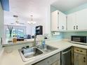 Open concept kitchen featuring a stainless steel dishwasher and a breakfast bar at 3650 Ne 21St St, Ocala, FL 34470