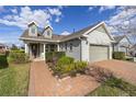 Attractive home with a well-kept lawn, brick paved driveway, and covered front porch with seating at 5563 Nw 40Th Pl, Ocala, FL 34482